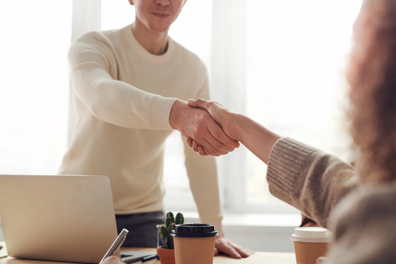 Photo of Man and Woman Shaking Hands
