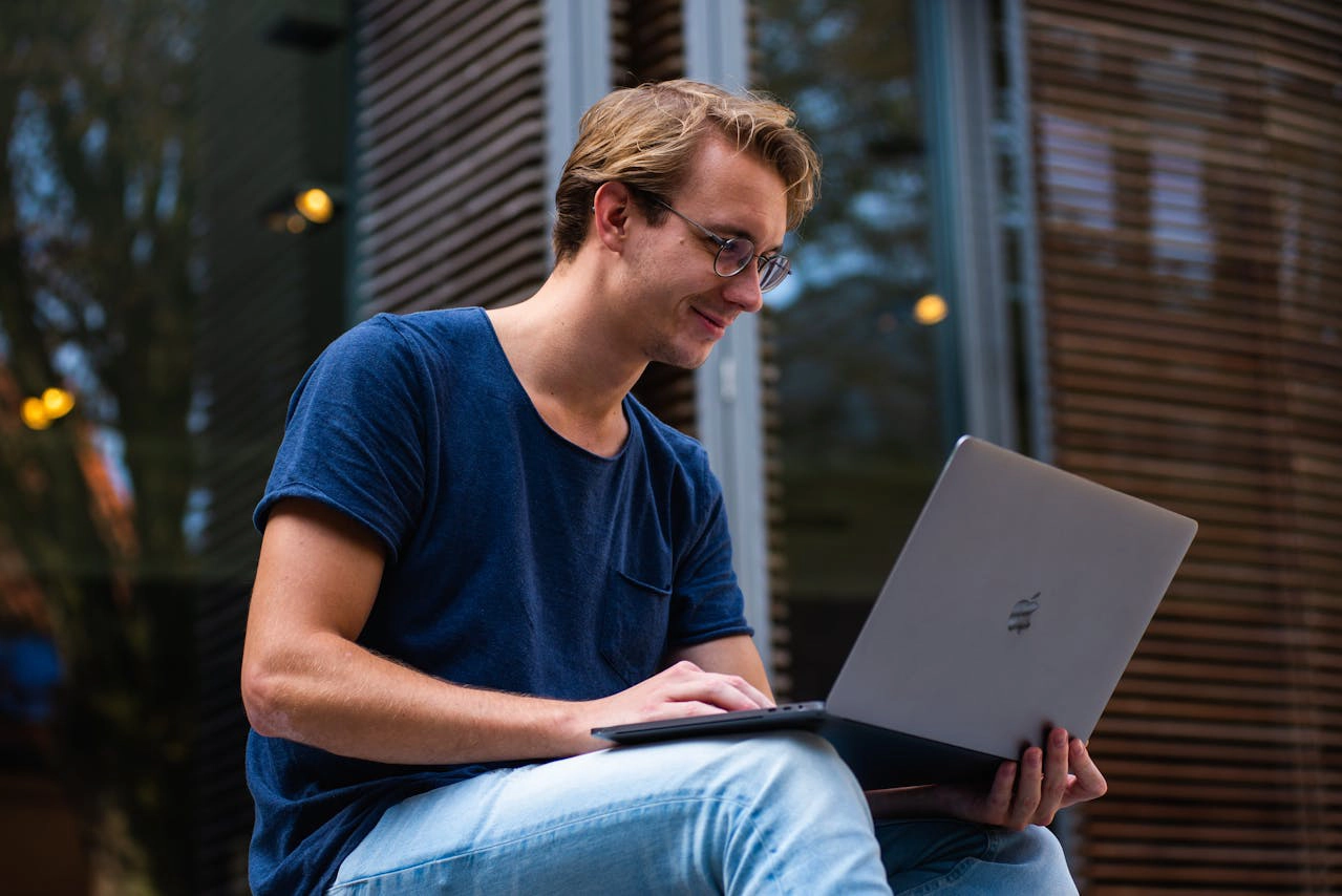 Photo of Man Holding Laptop